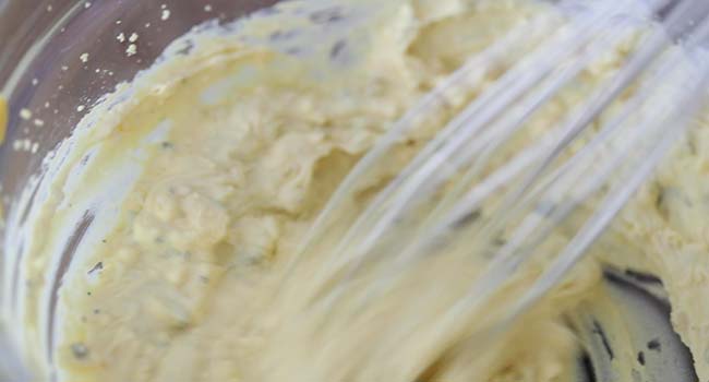 whisking a southern deviled egg filling