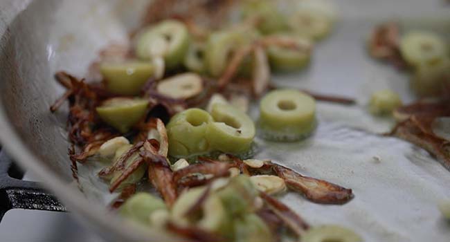 cooked olives and onions in a pan