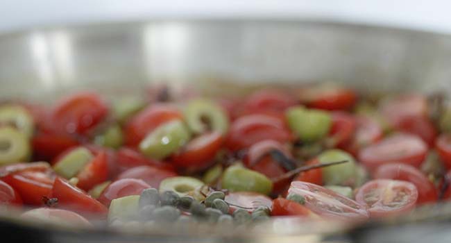 sautéing tomatoes and olives