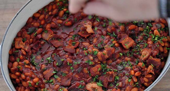 garnishing baked beans with parsley