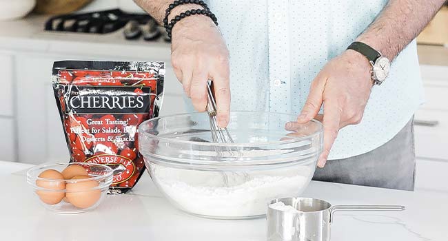 mixing a bowl of flour and eggs