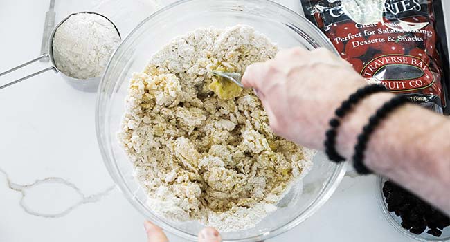 mixing together a biscotti dough with a fork