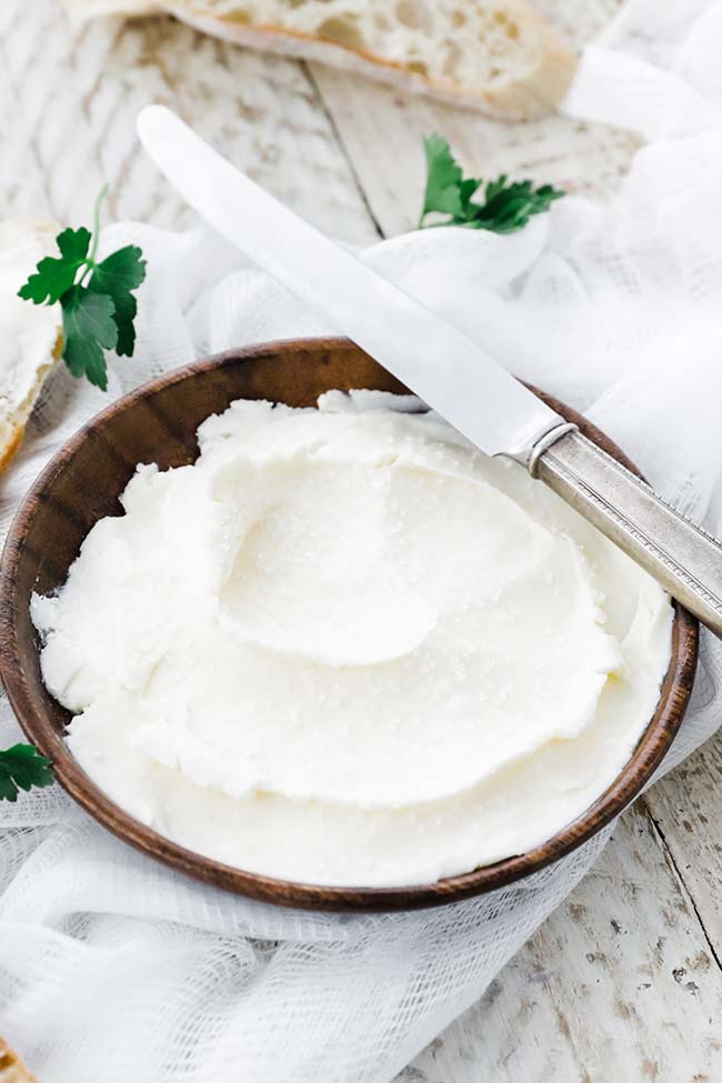 small plate of butter with parsley and salt