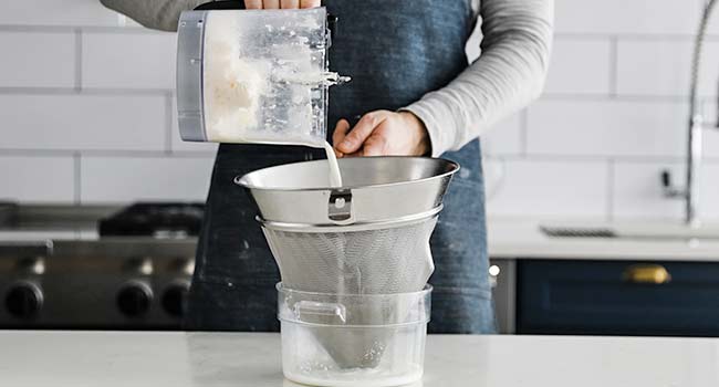 straining buttermilk away from butter