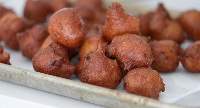 draining fried hush puppies on paper towels