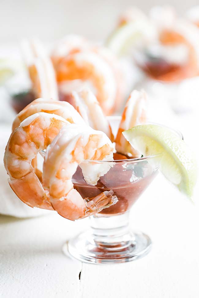 shrimp cocktail in a cocktail glass with lemon