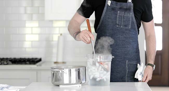 adding cooked shrimp to an ice bath