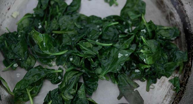 cooking spinach in a pan