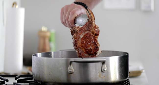 pan searing a stuffed bone-on pork chop