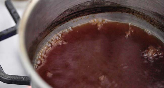 cooking a beef stock in a pot