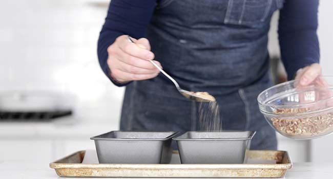 sprinkling a crumb topping over zucchini bread