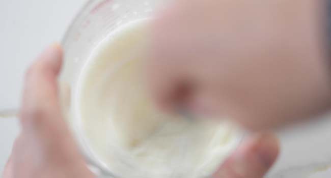adding milk and butter milk to a bowl