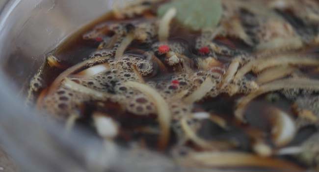 whisking together a marinade for chicken adobo