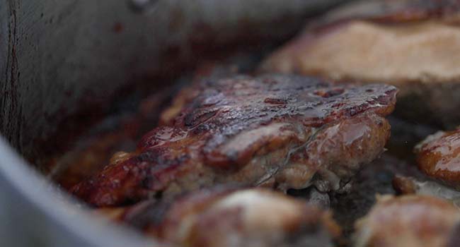 pan searing chicken adobo in a pan