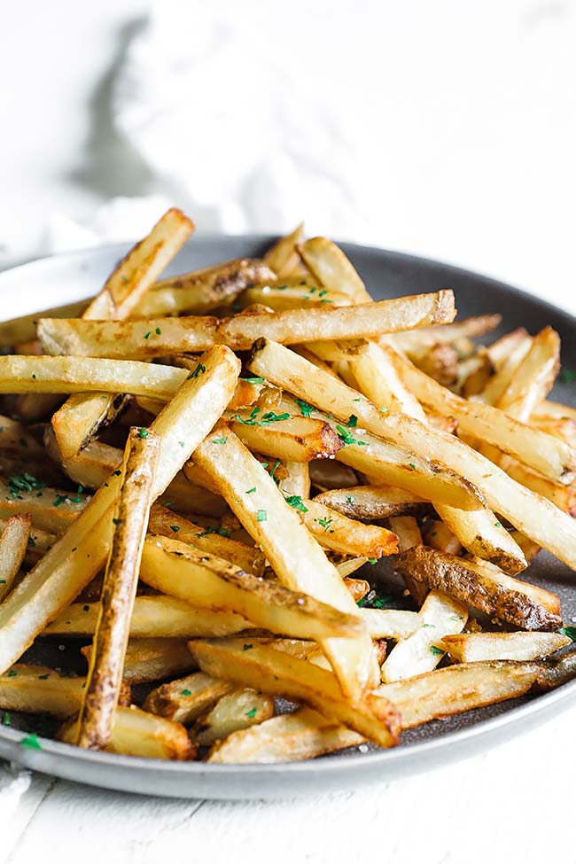a plate of belgian style french fries