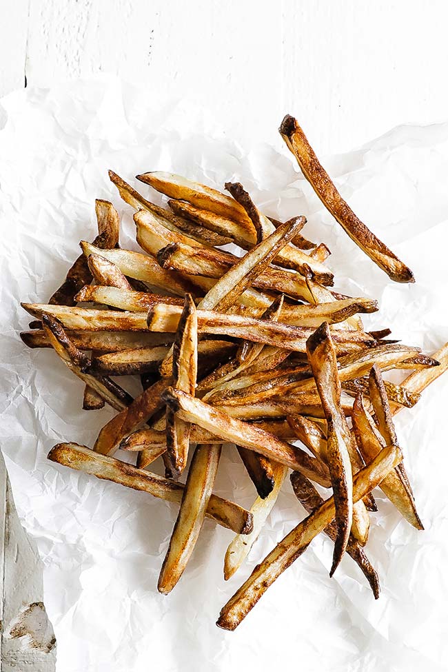 oven baked french fries on parchment paper