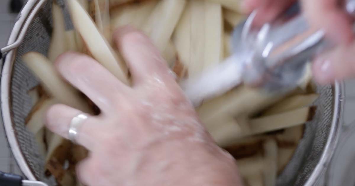 draining the sliced pommes frites