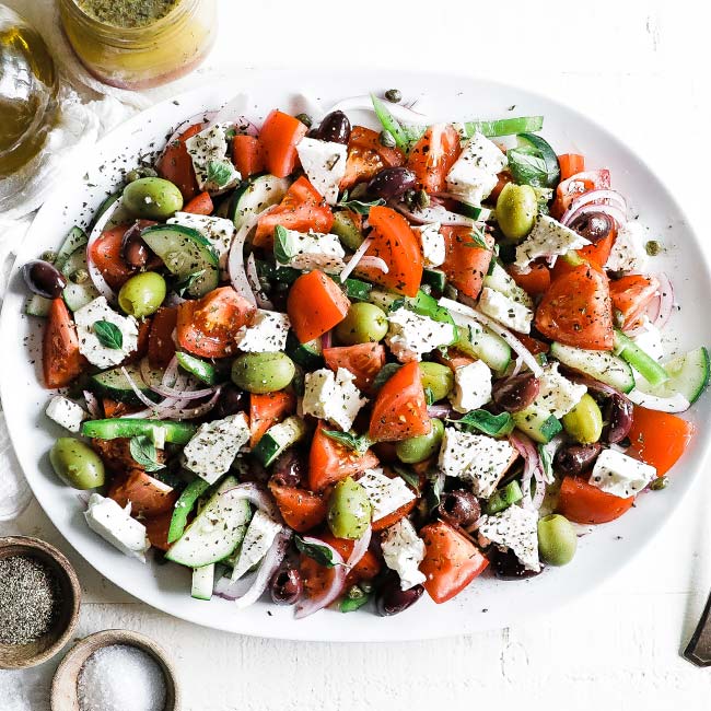 greek salad with vegetables on a platter