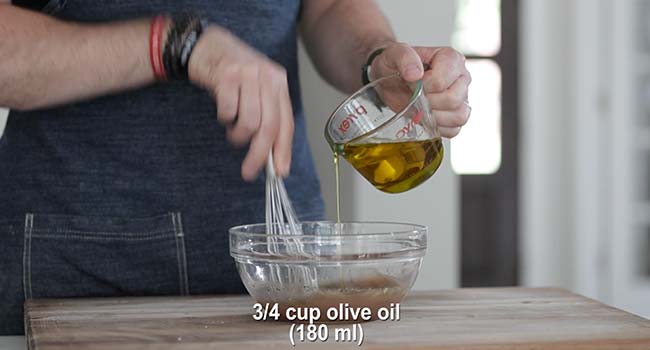 slowly drizzling in olive oil to a greek salad dressing