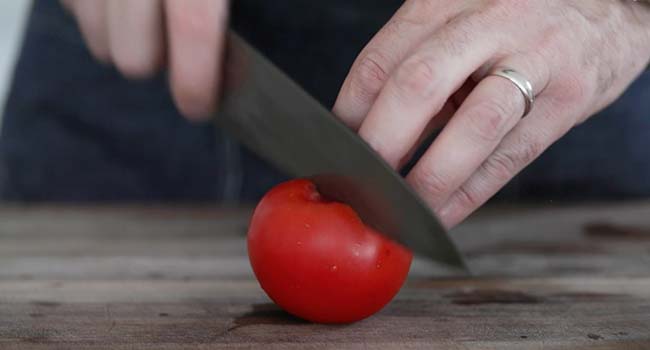 slicing a vine ripe tomato