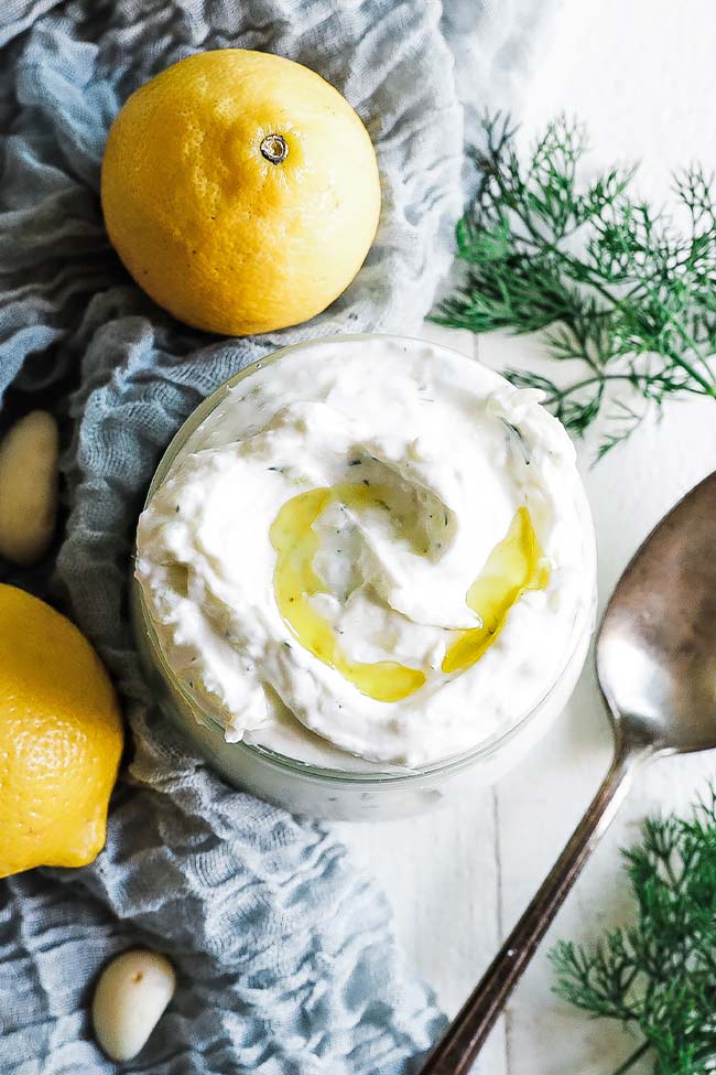 bowl of tzatziki with olive oil and lemon