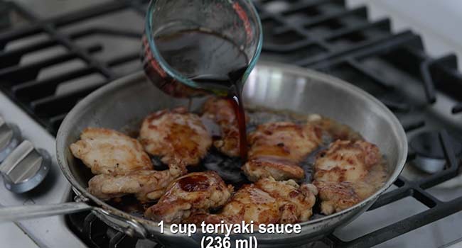 adding teriyaki sauce to cooked chicken