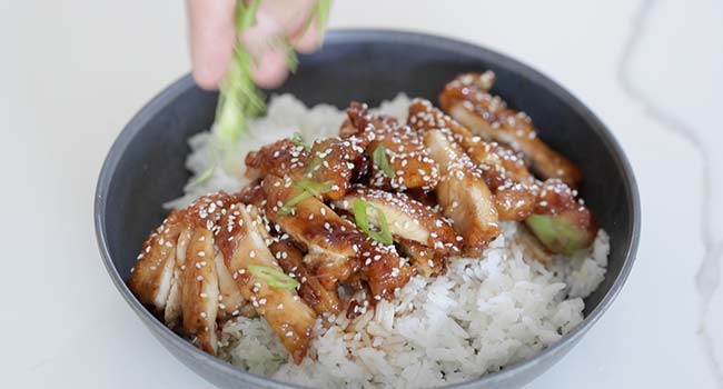 garnishing chicken teriyaki with green onions