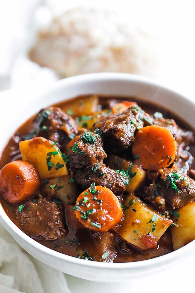 bowl of goulash served with bread