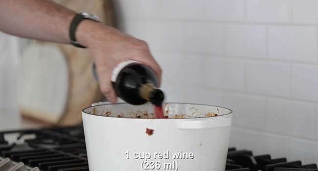 deglazing a pot of food with red wine