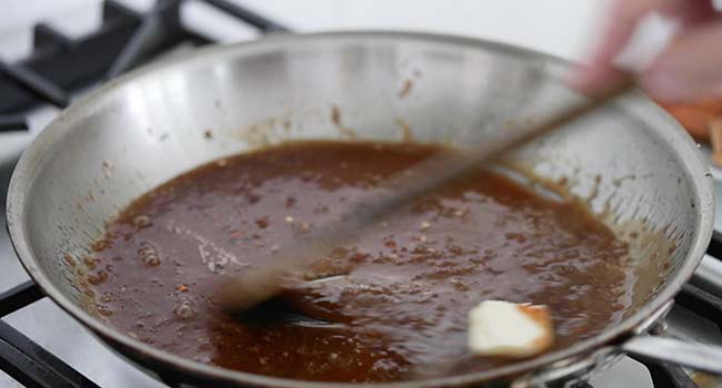 mixing a sauce together in a pan with butter