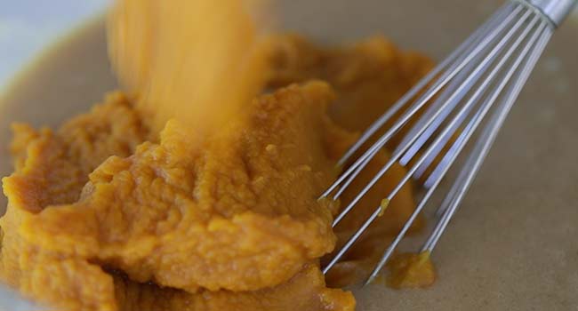 whisking pumpkin puree with batter