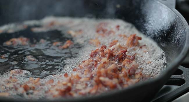 cooked bacon lardons in a pan