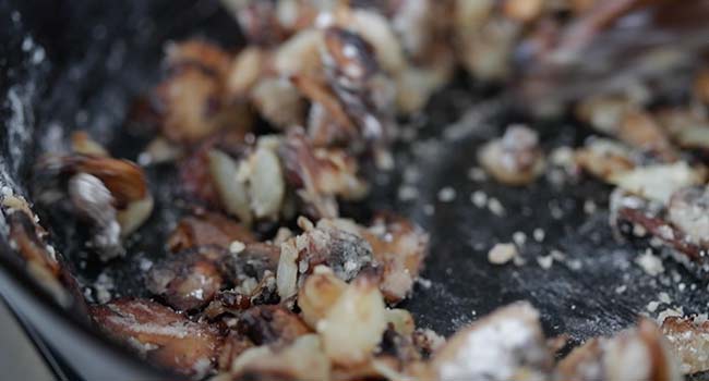 cooked mushrooms with garlic in a pan