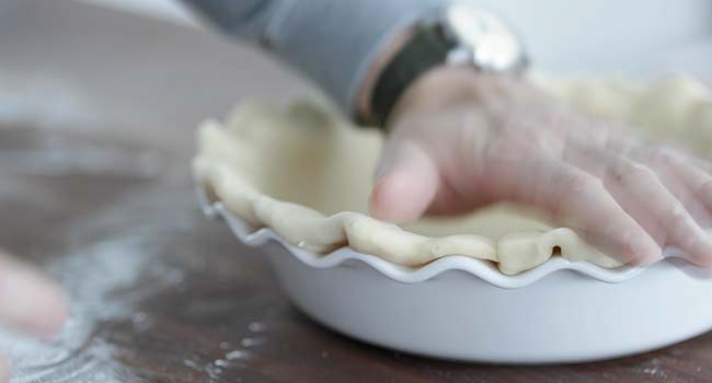 forming a pie crust to a pie tin