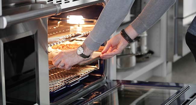 placing a pie in the oven