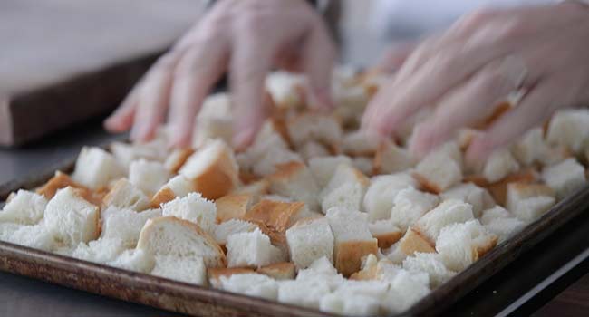 cubed bread on a cookie sheet tray