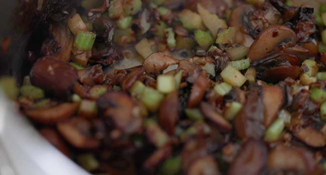 cooked mushrooms and celery in a pan