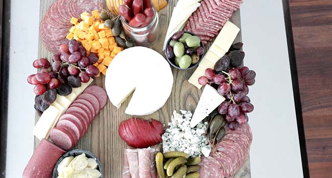 fruit and vegetables on a meat and cheese board