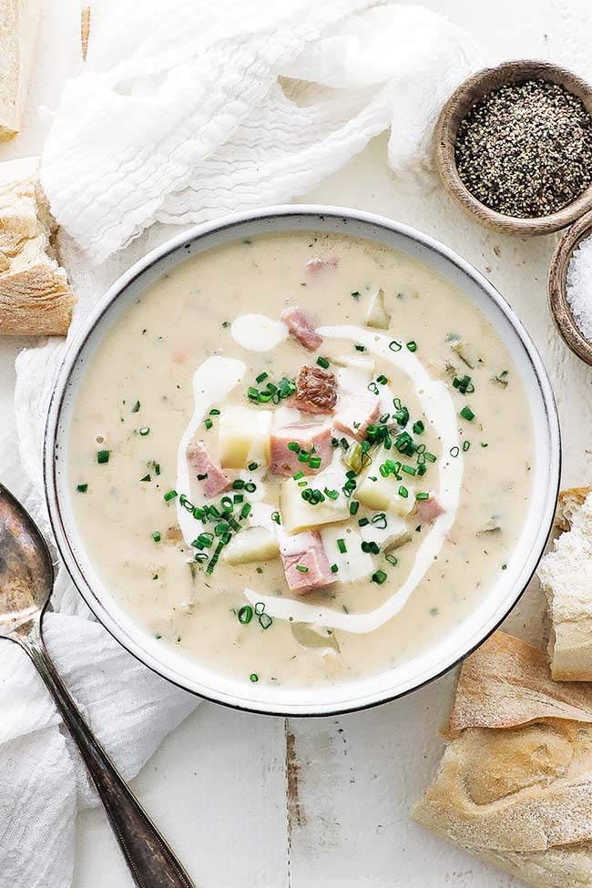 bowl of ham and potato soup with chives