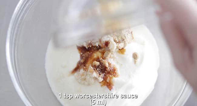 adding Worcestershire sauce to a bowl with creme fraiche
