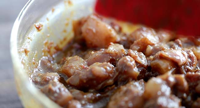 marinating chicken in a bowl