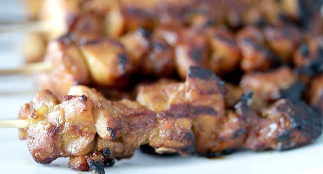 garnishing grilled chicken satay