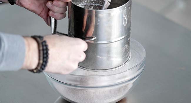 sifting flour into a bow