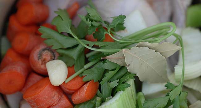 vegetables and chicken in a stockpot 