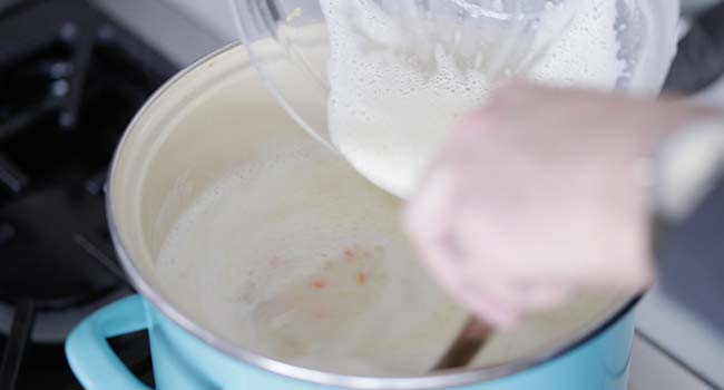 pouring the avgolemono into the soup