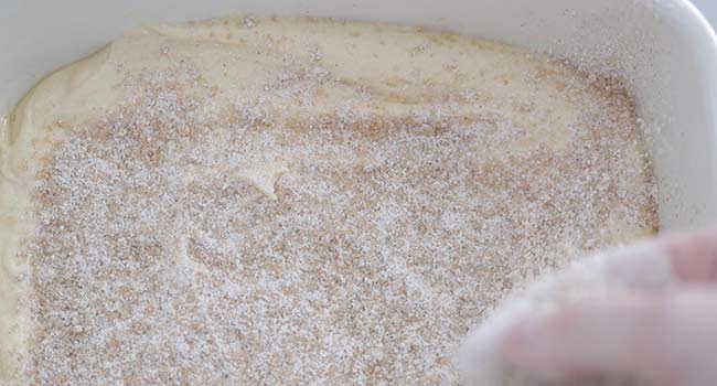 sprinkling filling overtop a batter