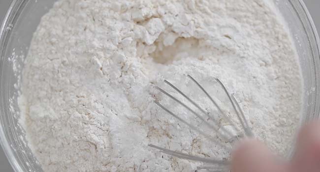 mixing together dry flour ingredients