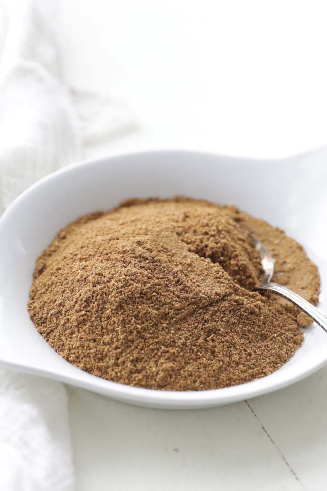 garam masala powder recipe with a spoon on a plate