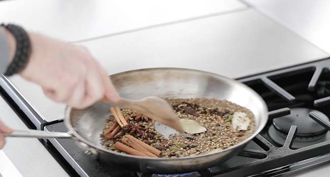 toasting garam masala spices in a pan