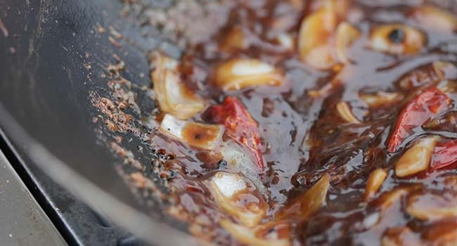 mongolian beef sauce cooking in a wok